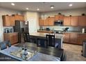 Spacious kitchen with island, stainless steel appliances, and ample cabinetry at 5744 W Siesta Way, Laveen, AZ 85339