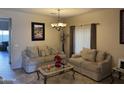 Living room with two sofas, coffee table, and decorative accents at 5744 W Siesta Way, Laveen, AZ 85339