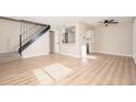 Bright and spacious living room with wood-look flooring and ceiling fan at 5855 N 48Th Ave, Glendale, AZ 85301