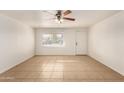 Simple living room with tile floors and a ceiling fan at 5932 W Holly St, Phoenix, AZ 85035