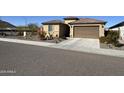 House exterior with a two-car garage and landscaping at 6516 W Madre Del Oro Dr, Phoenix, AZ 85083