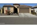 One-story home with brown garage door and drought-tolerant landscaping at 6516 W Madre Del Oro Dr, Phoenix, AZ 85083