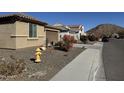 Street view of a house with desert landscaping and a mountain in the background at 6516 W Madre Del Oro Dr, Phoenix, AZ 85083