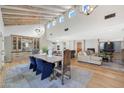 Open concept dining area with wood floors and exposed beams at 6912 E Larkspur Dr, Scottsdale, AZ 85254