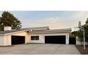 Modern two-car garage with dark-colored doors and clean concrete driveway at 6912 E Larkspur Dr, Scottsdale, AZ 85254