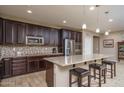 Modern kitchen with island, stainless steel appliances, and tile flooring at 7934 W Andrea Dr, Peoria, AZ 85383