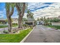 Community entrance showcasing beautiful landscaping, mature trees, and a secure gated entry at 8243 E Cortez Dr, Scottsdale, AZ 85260