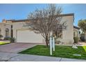 Charming single-story home with a well-maintained lawn, two-car garage and desert landscaping at 8243 E Cortez Dr, Scottsdale, AZ 85260