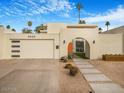 Mid-century modern home with a landscaped front yard and gated entry at 8626 E Mackenzie Dr, Scottsdale, AZ 85251