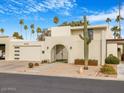 Mid-century modern home with a landscaped front yard and gated entry at 8626 E Mackenzie Dr, Scottsdale, AZ 85251