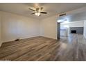 Spacious living room with wood-look floors and fireplace at 8651 W Glenrosa Ave, Phoenix, AZ 85037