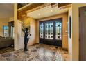 Elegant entryway with arched, iron doors and tiled floors at 9135 E Buckskin Trl, Scottsdale, AZ 85255