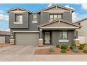 Two-story home with gray siding, stone accents, and a two-car garage at 9354 E Sector Dr, Mesa, AZ 85212