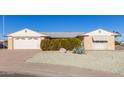 Ranch style home with a spacious yard and attached garage at 9526 W Briarwood N Cir, Sun City, AZ 85351