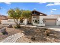 Beautiful desert landscaping highlights this updated single-level home at 9915 E Cinnabar Ave, Scottsdale, AZ 85258