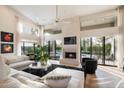 Bright and airy living room with floor to ceiling windows, fireplace and pool view at 11748 N 80Th Pl, Scottsdale, AZ 85260