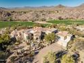 Luxury estate overlooking golf course features barrel tile roof and desert landscaping with stunning mountain views at 10420 E Morning Vista Ln, Scottsdale, AZ 85262