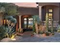 Elegant front entrance with stone accents and desert landscaping creates curb appeal at 10922 E Purple Aster Way, Scottsdale, AZ 85262