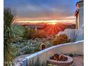A cozy outdoor firepit with desert landscaping and scenic sunset views of the mountains at 13503 E Summit Dr, Scottsdale, AZ 85259
