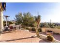 Outdoor patio with seating, fire pit, and scenic desert views at 13503 E Summit Dr, Scottsdale, AZ 85259