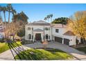 Elegant two-story home with circular driveway and lush landscaping at 1519 E Treasure Cove Dr, Gilbert, AZ 85234