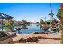 Stunning pool and patio area with lake views and a waterfall feature at 1519 E Treasure Cove Dr, Gilbert, AZ 85234