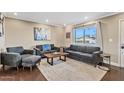 Living room with hardwood floors, gray sofas and a large window at 1637 N Bridalwreath St, Tempe, AZ 85288