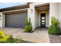 Inviting entryway with a modern door and landscaping at 17535 E Silver Sage Ln, Rio Verde, AZ 85263