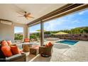 Relaxing covered patio with seating area overlooking the pool at 17535 E Silver Sage Ln, Rio Verde, AZ 85263