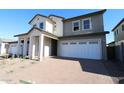Charming two-story home featuring a two-car garage and a welcoming covered entryway with substantial pillars at 1932 W Rowel Rd, Phoenix, AZ 85085