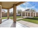Landscaped backyard with artificial turf, a gazebo, and a covered patio at 224 S 151St Ave, Goodyear, AZ 85338