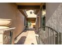 Courtyard entry with a brick pathway and wrought-iron gate at 2446 W Myopia Dr, Anthem, AZ 85086