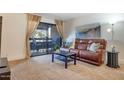 Relaxing living room with recliner sofa and balcony access at 3825 E Camelback Rd # 239, Phoenix, AZ 85018