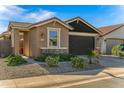 Inviting single-story home with a manicured front yard, and a two-car garage at 41233 W Carlisle Ln, Maricopa, AZ 85138