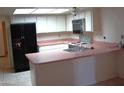 Efficient kitchen featuring pink countertops and appliances at 4234 E Winnetka Dr, Phoenix, AZ 85044