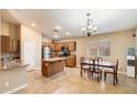 Kitchen with an island, stainless steel appliances, and wood cabinets at 45513 W Sky Ln, Maricopa, AZ 85139