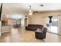 Spacious living room with tile floors and a comfortable sectional sofa at 45513 W Sky Ln, Maricopa, AZ 85139
