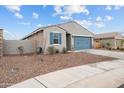 Charming one-story home with gray exterior, blue garage door, and desert landscaping at 4887 N 179Th Dr, Goodyear, AZ 85395