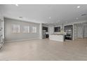 Bright living space with tile floors, recessed lighting, and a view of the modern kitchen, creating an inviting atmosphere at 5525 N 193Rd Dr, Litchfield Park, AZ 85340