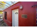 Red brick home with white pergola and a historic marker at 5543 W Gardenia Ave, Glendale, AZ 85301