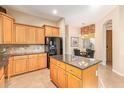 Kitchen features an island with granite countertops and light wood cabinetry at 6202 E Mckellips Rd # 42, Mesa, AZ 85215