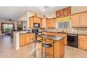 Spacious kitchen with light wood cabinets, granite island, and stainless steel appliances at 6202 E Mckellips Rd # 42, Mesa, AZ 85215
