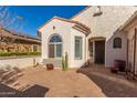 Brick paver courtyard with entrance to home and cacti at 6280 W Saratoga Way, Florence, AZ 85132