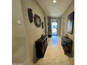 Elegant hallway with tile floors, neutral walls, and decorative mirrors and artwork at 6516 W Madre Del Oro Dr, Phoenix, AZ 85083