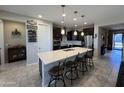Contemporary kitchen with a large island, dark cabinetry, and stainless steel appliances at 6516 W Madre Del Oro Dr, Phoenix, AZ 85083