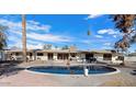 Kidney shaped pool in backyard with patio furniture at 7011 E Jackrabbit Rd, Paradise Valley, AZ 85253