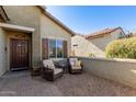 Relaxing front patio with two wicker chairs and small side table at 7089 W Pleasant Oak Ct, Florence, AZ 85132