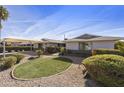 Attractive mid-century modern home with well-manicured landscaping and a spacious front yard at 8631 E Vista Dr, Scottsdale, AZ 85250