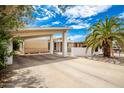 Mid-century home with carport, palm trees, and rock landscaping at 10461 W Devonshire Ave, Phoenix, AZ 85037