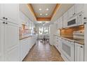 Bright kitchen with white cabinets and tile flooring at 10631 W Brookside Dr, Sun City, AZ 85351